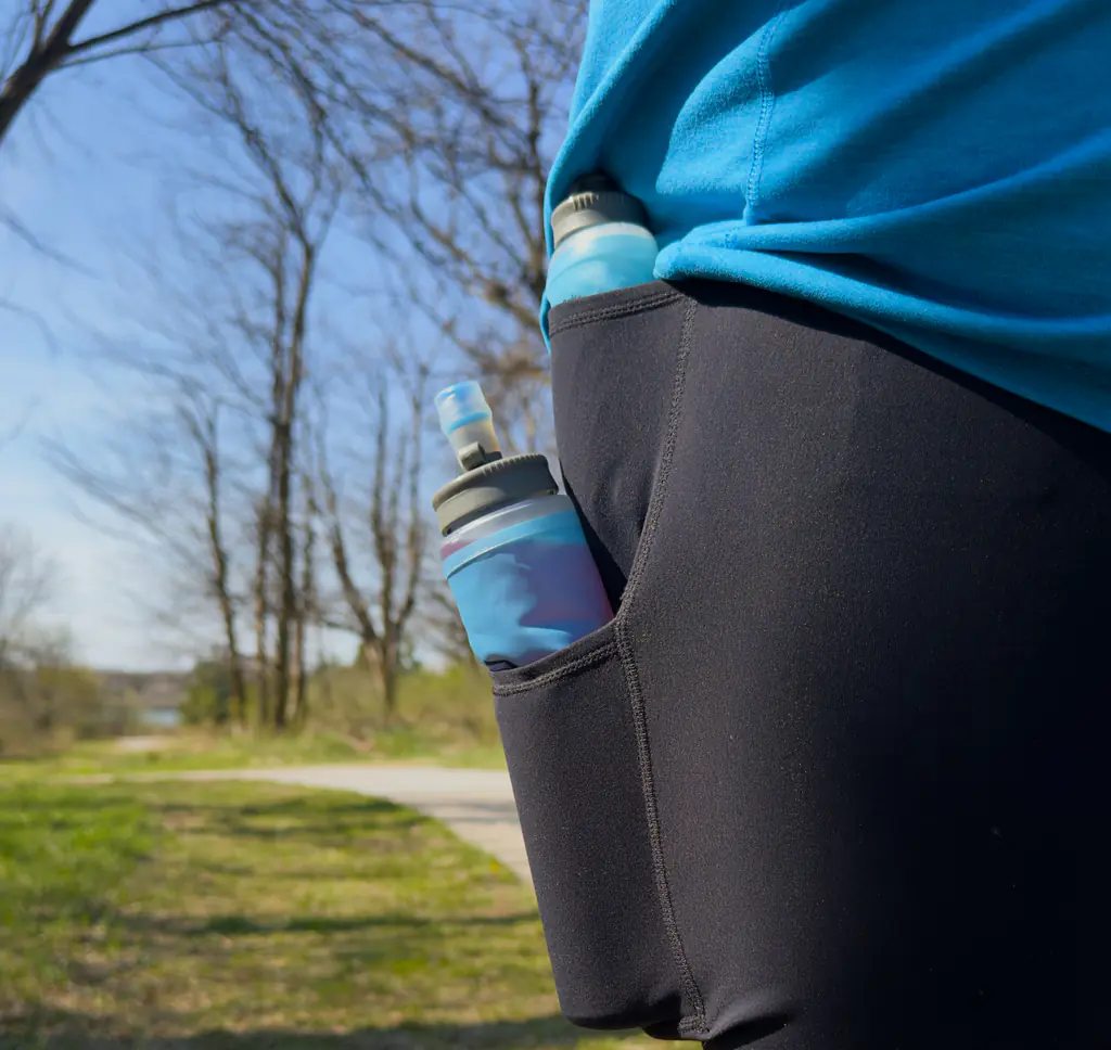 A shot of a 500ml hydration soft flask in the bottom side pocket and a 150ml nutrition soft flask in the top side pocket. Each fits, with a little bit hanging out of the top. A shot of a 500ml hydration soft flask in the bottom side pocket and a 150ml nutrition soft flask in the top side pocket. Each fits, with a little bit hanging out of the top.