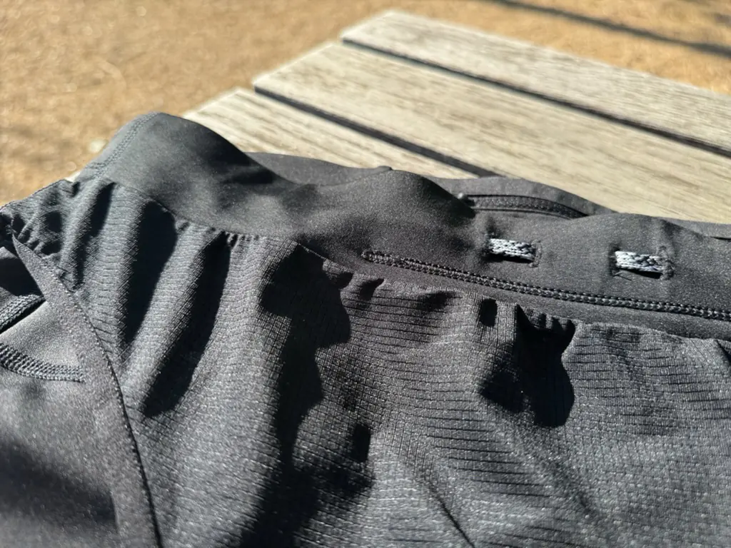 A close up shot of the waistband, showing the simple construction and the internal/external drawstring routing holes A close up shot of the waistband, showing the simple construction and the internal/external drawstring routing holes