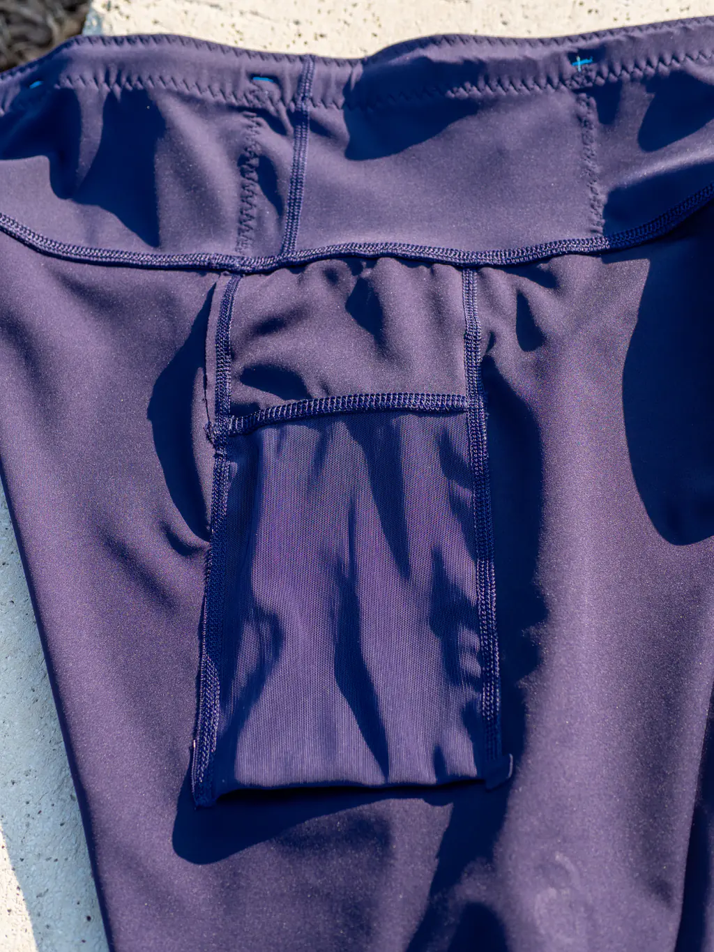 An inside view of the thigh pocket, showing the folded mesh inset into the leg, with no bottom stitching