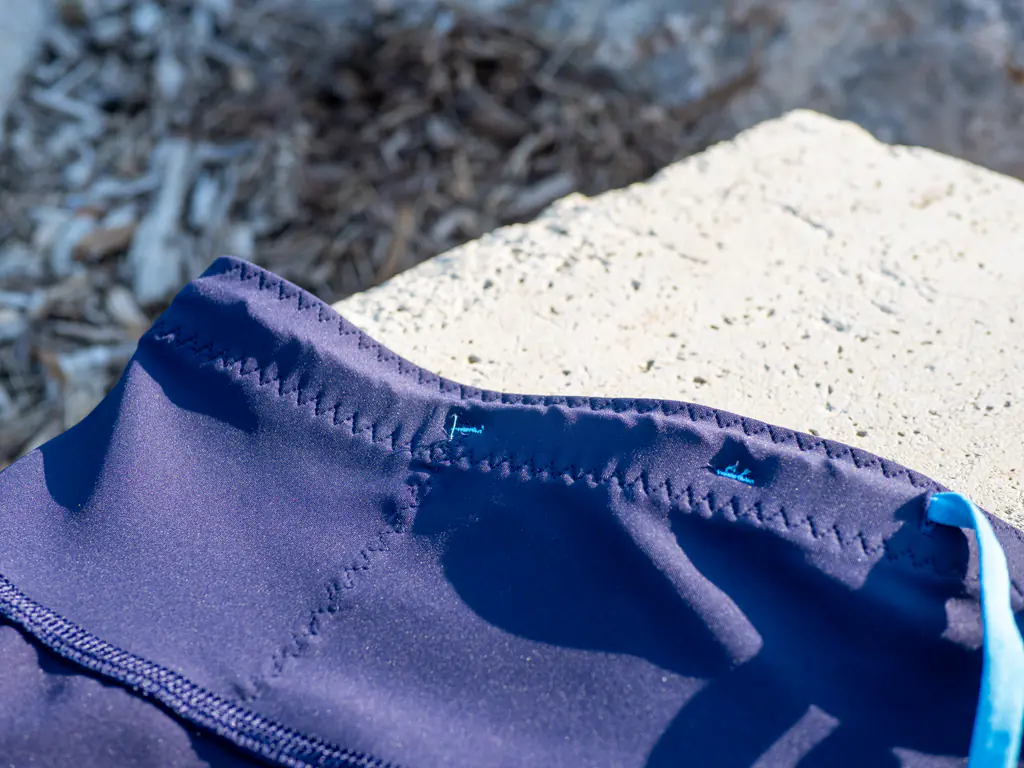 A closeup of the waistband storage, showing the separator stitches that segment the stretch-mesh