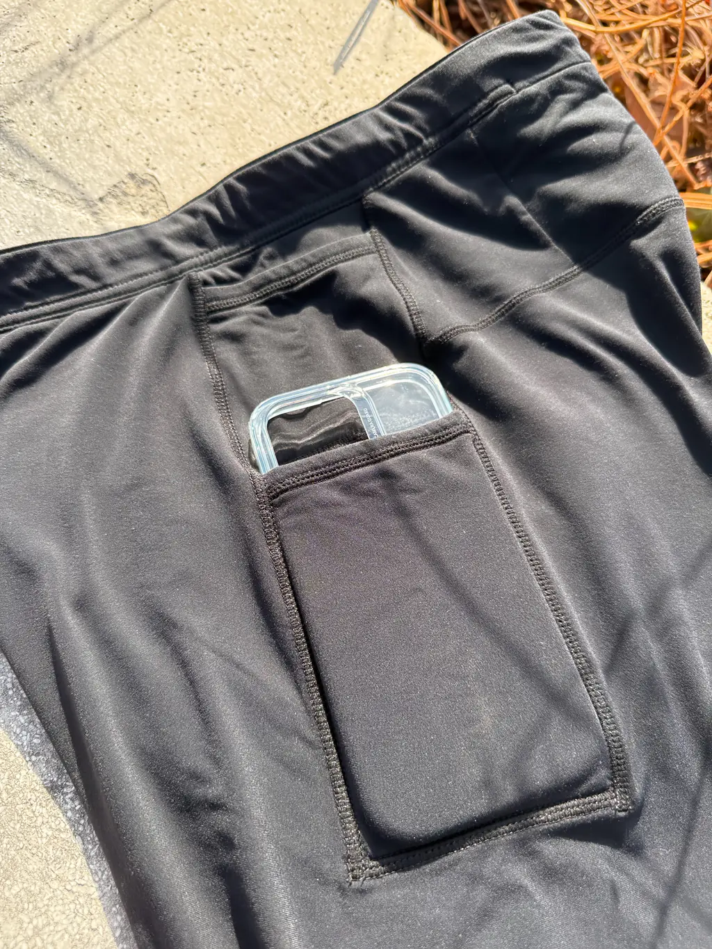 A closer shot of an iPhone 16 Pro case in the larger (bottom) pocket, showing the fit (a little bit of the camera segment and top of iPhone stick out of the top) A closer shot of an iPhone 16 Pro case in the larger (bottom) pocket, showing the fit (a little bit of the camera segment and top of iPhone stick out of the top)