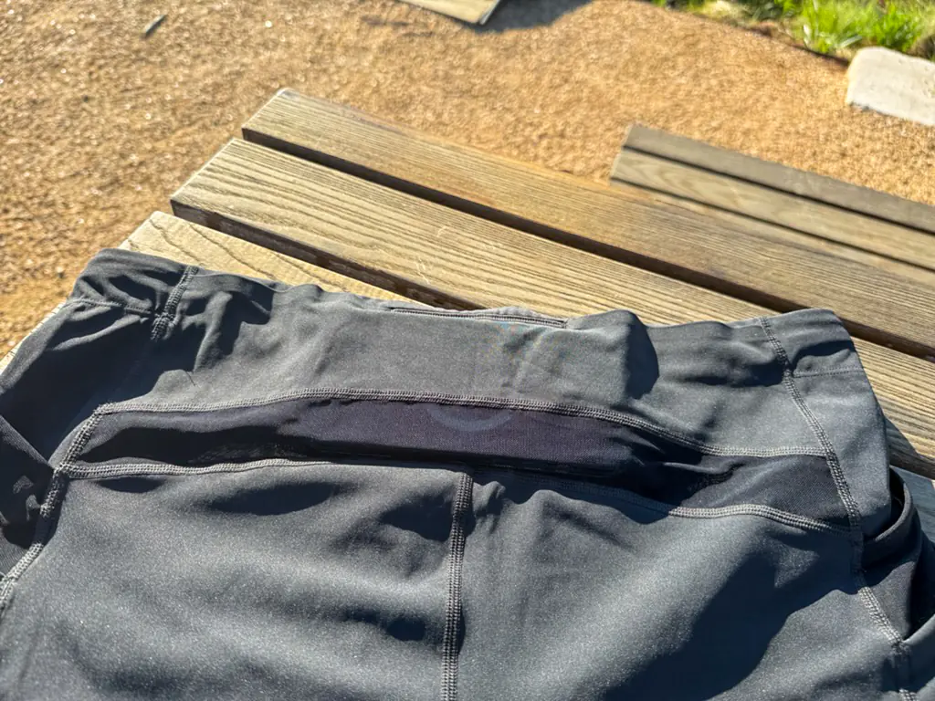A view of the rear pocket system, with an iPhone Pro Max case nestled in the middle, in the section with a closed off top seam. A view of the rear pocket system, with an iPhone Pro Max case nestled in the middle, in the section with a closed off top seam.