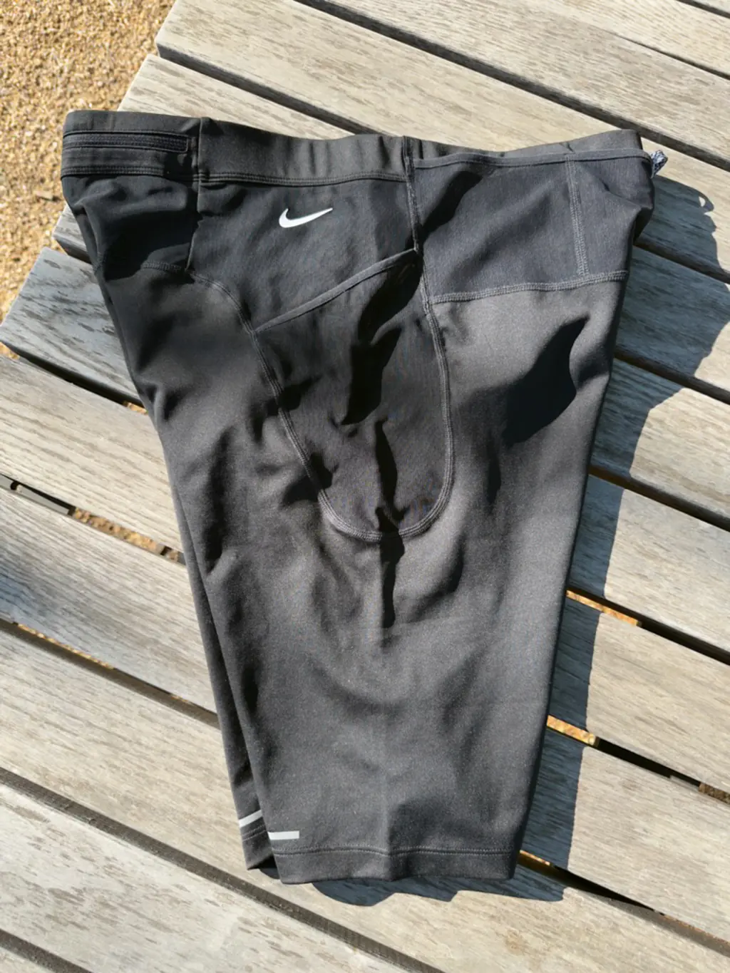 An overall side view of the half tights, showing the large, non-rectangular main side pocket An overall side view of the half tights, showing the large, non-rectangular main side pocket