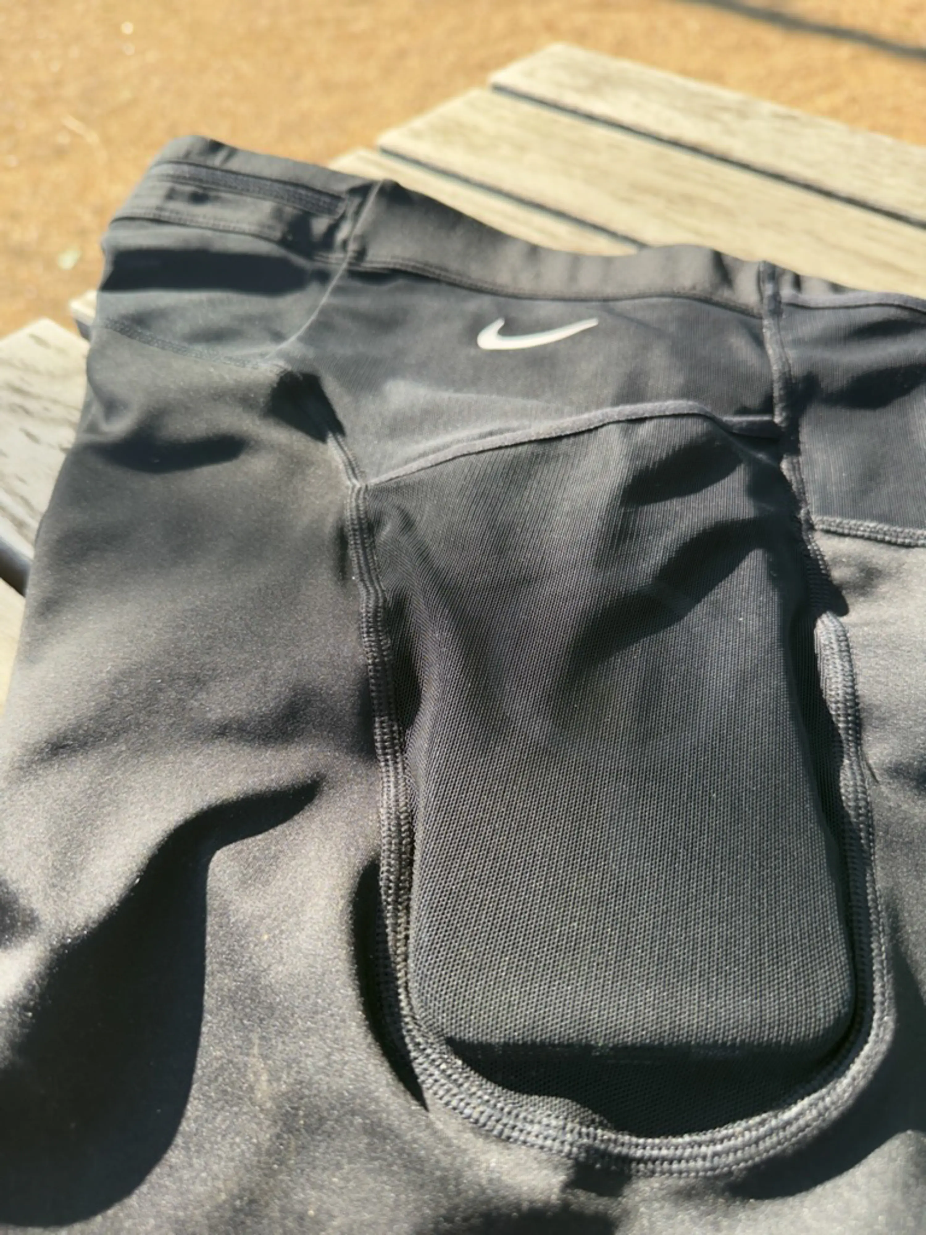 A close up view of the side pocket with an iPhone 12 Pro Max case in it, showing the case easily fits with plenty of room to spare